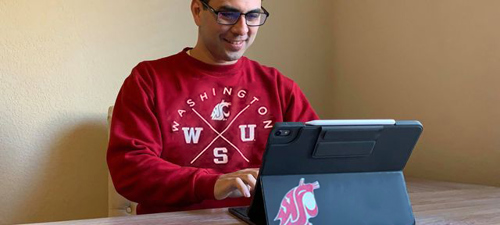 Global WSU student taking classes on a laptop